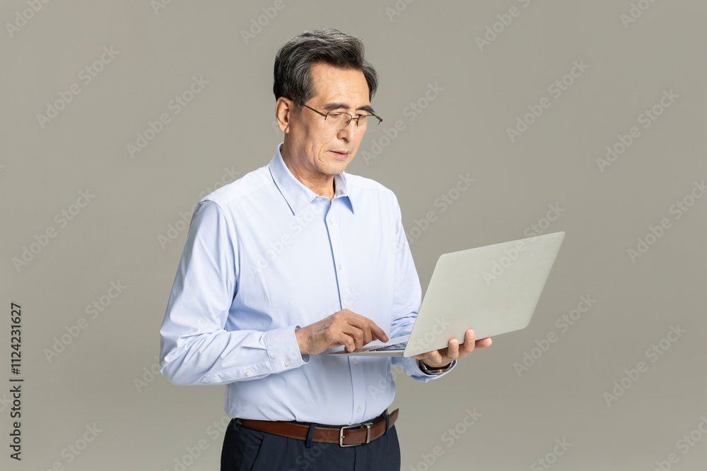 Senior male entrepreneur with laptop Senior male entrepreneur with laptop