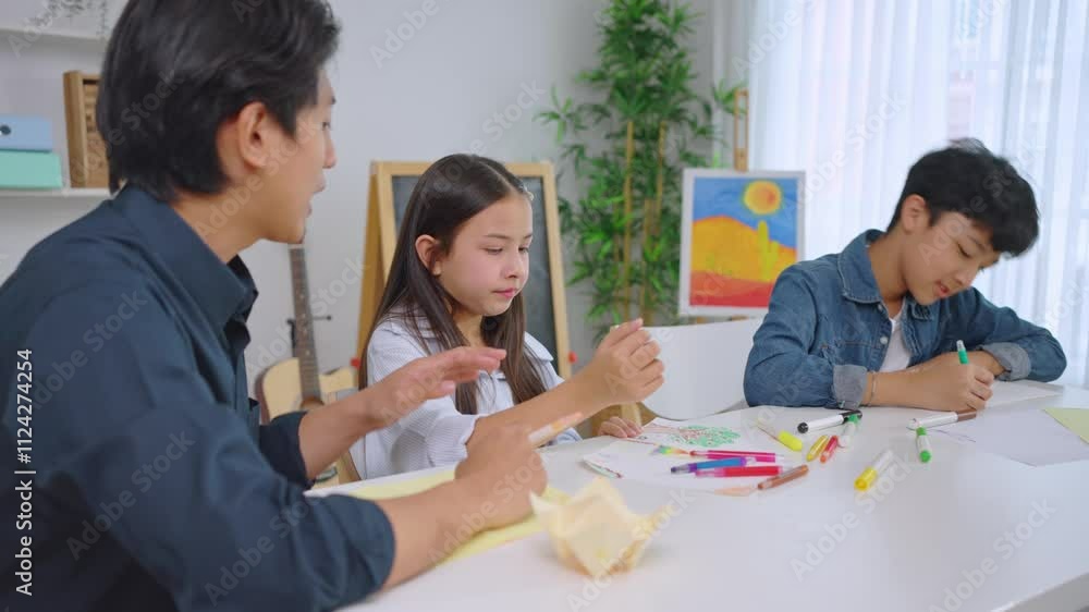 Asian teacher educating students in an art class at elementary school. Asian teacher educating students in an art class at elementary school.
