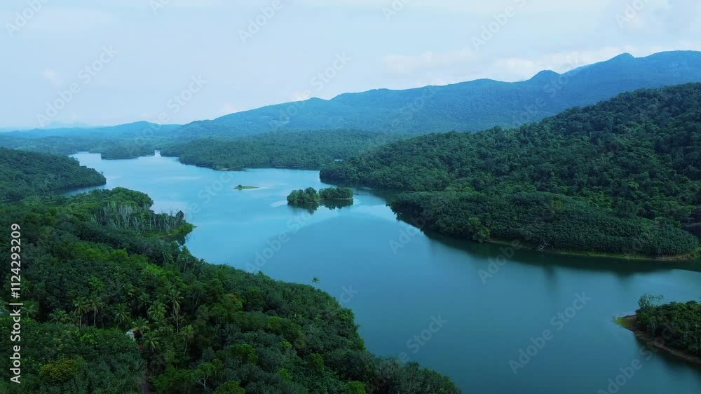 Western guts Areal view of a Beautiful reservoir dam in Kerala, India, Morning view of Neyyar dam, Mountains and small green islands are seen in this video Western guts Areal view of a Beautiful reservoir dam in Kerala, India, Morning view of Neyyar dam, Mountains and small green islands are seen in this video