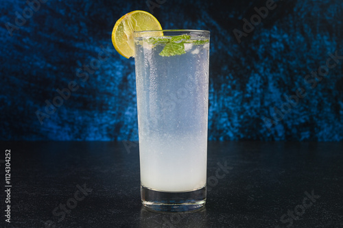 Lemon soda served in a glass cup.