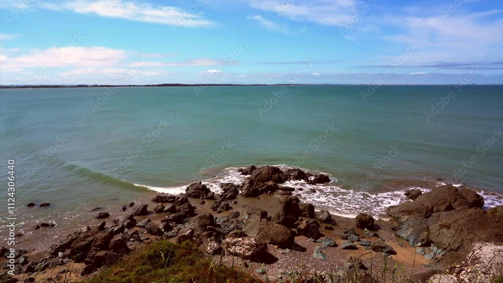 Waves Crashing Against Coastal Rocks in Scenic Seaside Landscape Waves Crashing Against Coastal Rocks in Scenic Seaside Landscape