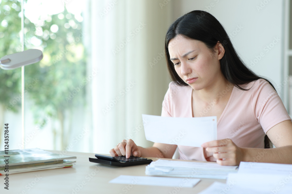 Concerned asian woman calculating holding bill Concerned asian woman calculating holding bill