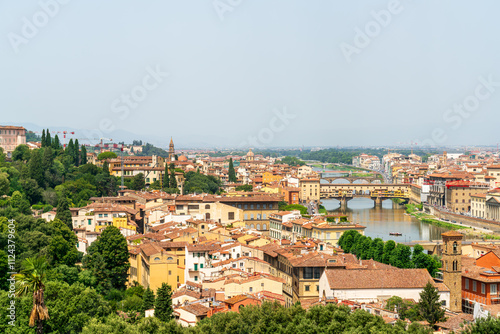 Florence, Italy. Ponte Vecchio. Medieval arched bridge with souvenir shops. Arno River. Panorama of the city. Summer day