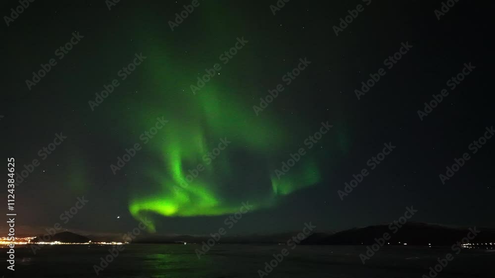 Time lapse of the Northern lights or Aurora Borealis over the sea Time lapse of the Northern lights or Aurora Borealis over the sea