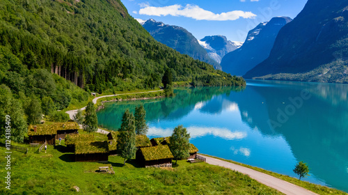 traditional Norwegian cabins with grass roofs nestled along the shore of a picturesque fjord surrounded by lush green mountains. lovatnet lake Lodal valley Norway photo