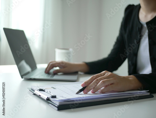 Young businesswoman holds a resume and evaluates it. Views the personal history of job applicants. Recruitment concept