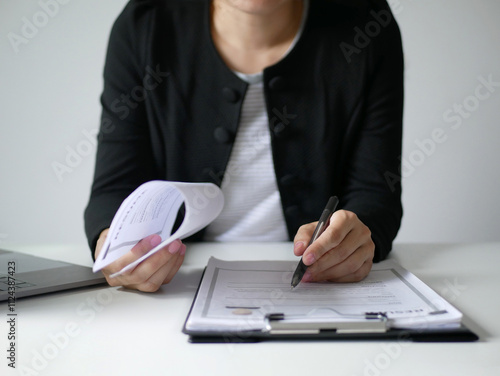 Young businesswoman holds a resume and evaluates it. Views the personal history of job applicants. Recruitment concept