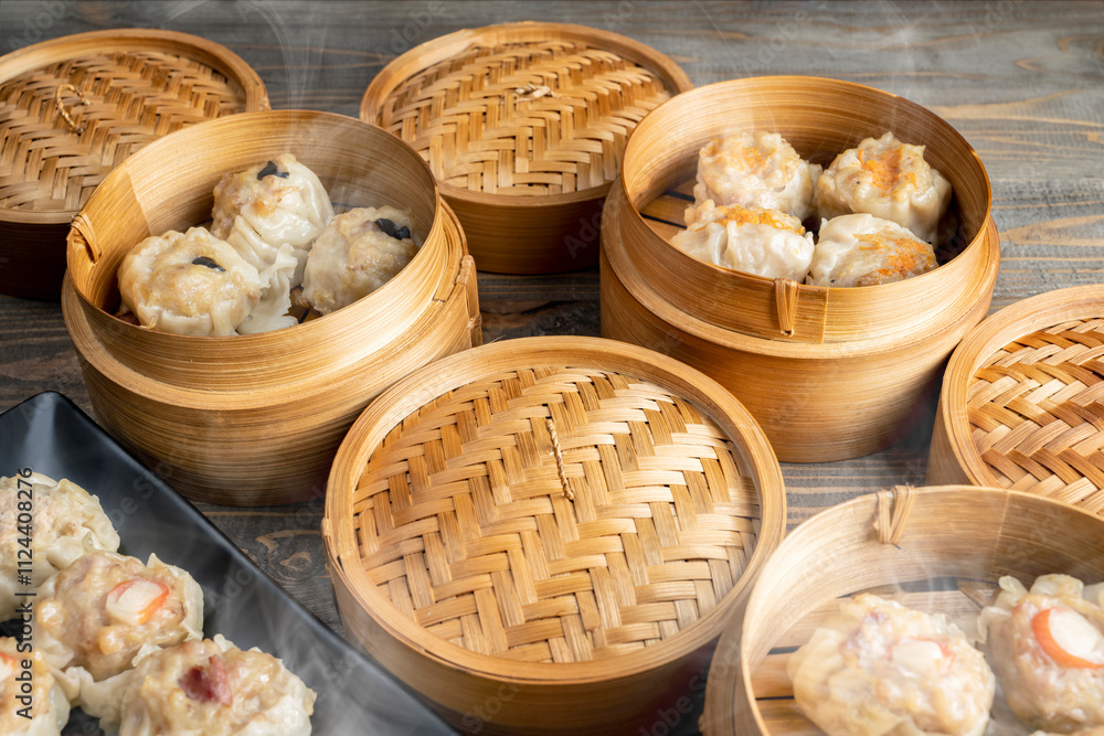 Assorted chinese dim sum dumpling on the plate with bamboo wooden basket bowl on wooden table Assorted chinese dim sum dumpling on the plate with bamboo wooden basket bowl on wooden table