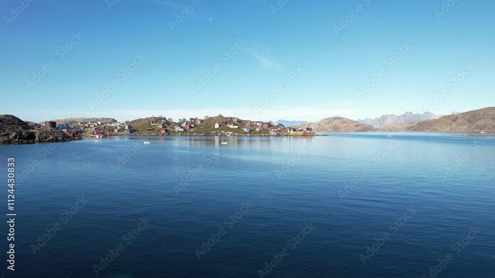 A typical small Inuit village (settlement) in Greenland. Filmed during the summer on a sunny day. A typical small Inuit village (settlement) in Greenland. Filmed during the summer on a sunny day.