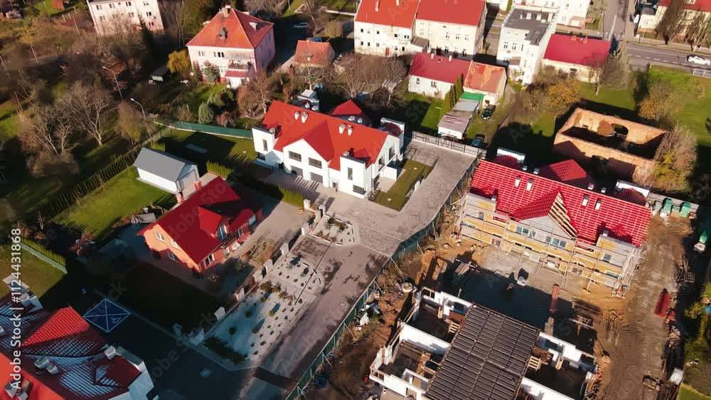 Aerial view of suburban neighborhood with newly constructed residential buildings and houses under construction in small town Aerial view of suburban neighborhood with newly constructed residential buildings and houses under construction in small town