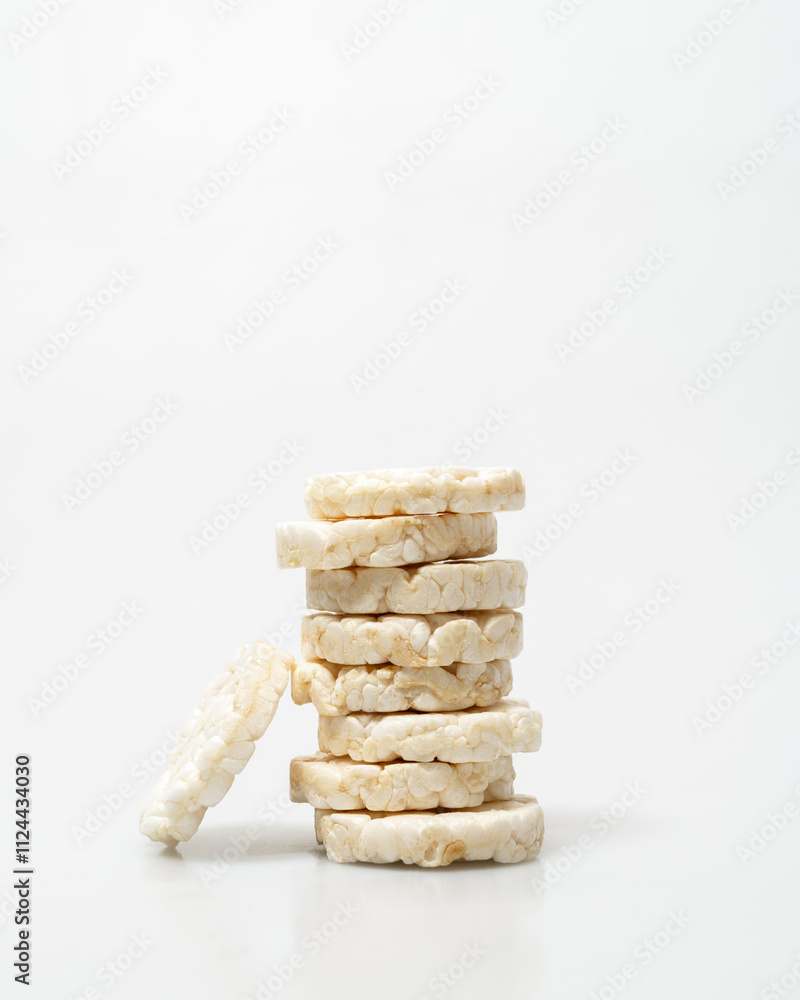 wheat rice breads tower, biscuits on a white background crumbled and whole