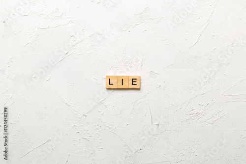 LIE word written on wood block. LIE text on cement table for your desing, concept photo