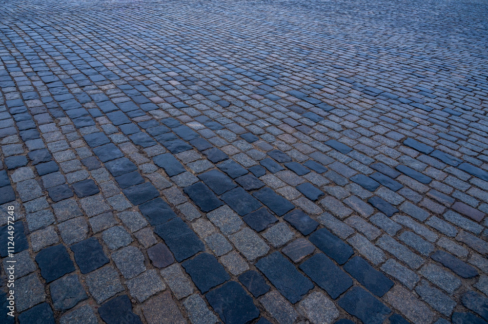 Fototapeta premium Paving stones. Stone pavement texture. Cobblestones on Red Square in Moscow. Perspective.