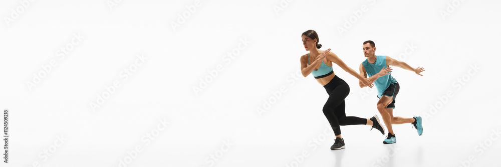 Athletic fit young woman and muscular young man, couple in sportswear training against white background. Cardio training. Concept of sport, active and healthy lifestyle, workout, fitness. Banner Athletic fit young woman and muscular young man, couple in sportswear training against white background. Cardio training. Concept of sport, active and healthy lifestyle, workout, fitness. Banner
