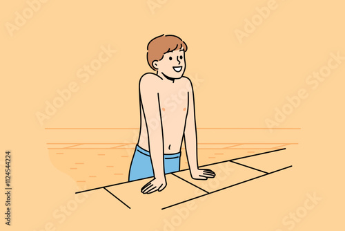 Boy gets out of pool and smiles after swimming in water, and rejoices at visiting aquapark. Happy child in swimming pool for sports training or summer recreation to improve health and get tan