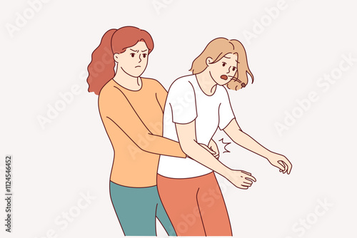 Heimlich technique is demonstrated by woman saving friend who was choking and pressing on stomach to restore breathing. Girl provides first aid and uses heimlich technique to avoid harm to health.