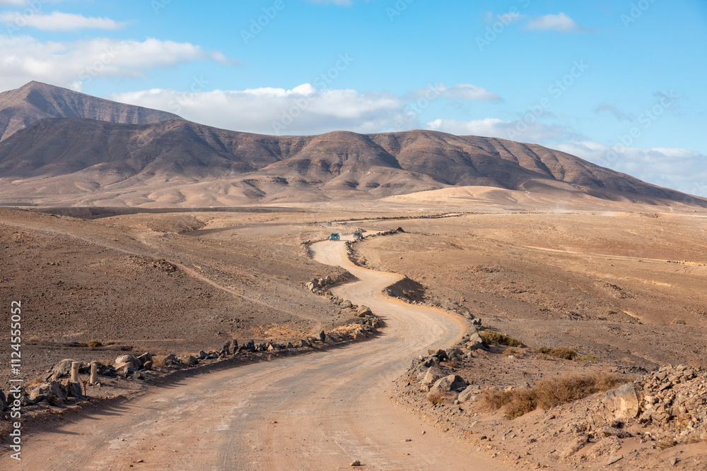 Winding gravel road through the arid desert landscape in Playa Blanca, Lanzarote, Spain. Winding gravel road through the arid desert landscape in Playa Blanca, Lanzarote, Spain.