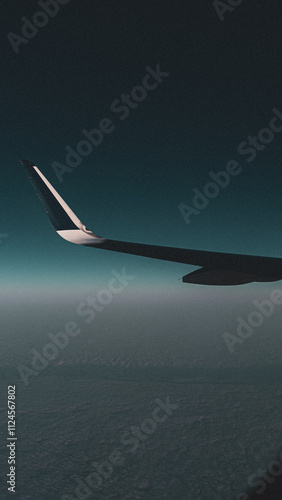 airplane wing over the clouds photo