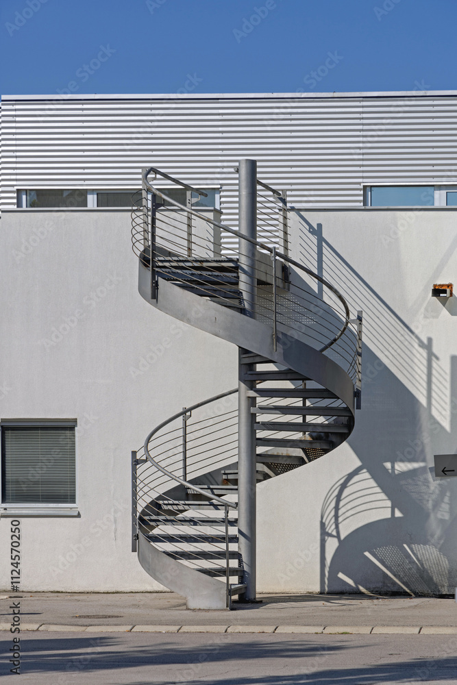 Metal Spiral Stairs to Nowhere at Industrial Building Exterior
