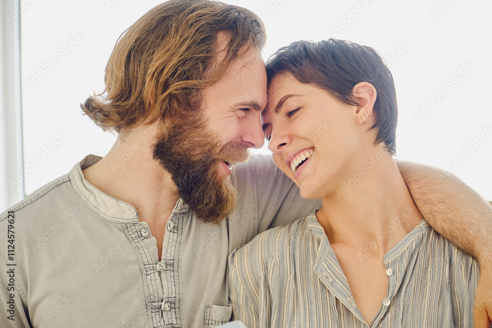 Happy man with arm around woman at home Happy man with arm around woman at home