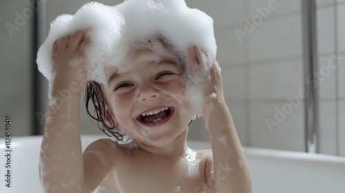 Modern child in the bathtub, with foam on head photo