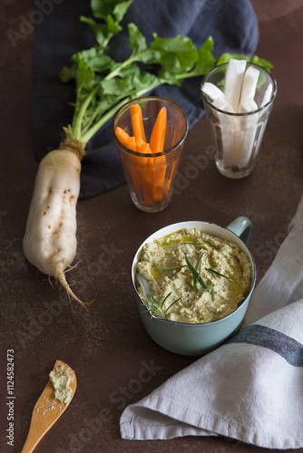 Artichoke pate with turnips and carrots in glass on table photo