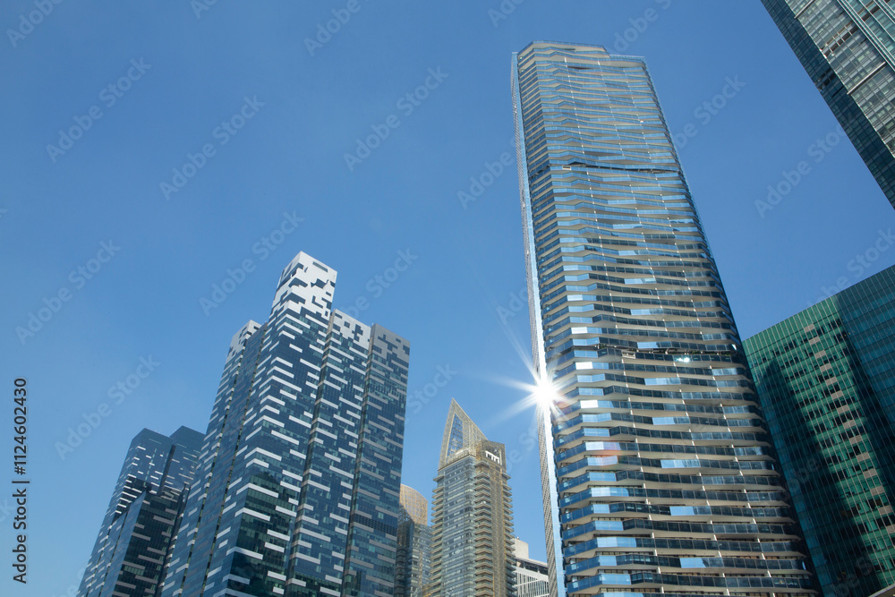 Modern skyscrapers in Singapore Marina Bay area with blue sky. Modern skyscrapers in Singapore Marina Bay area with blue sky.