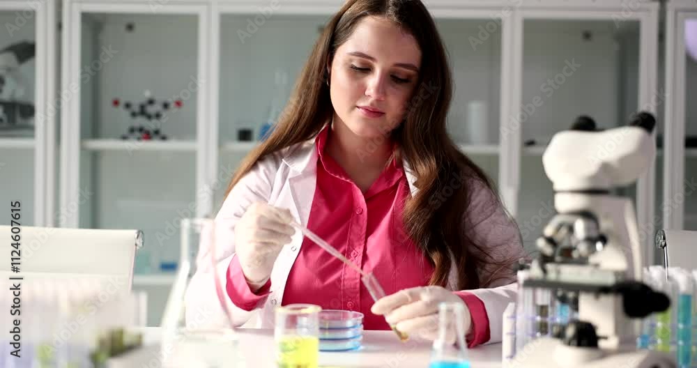 A committed and dedicated scientist diligently performing detailed experiments in a modern laboratory environment A committed and dedicated scientist diligently performing detailed experiments in a modern laboratory environment