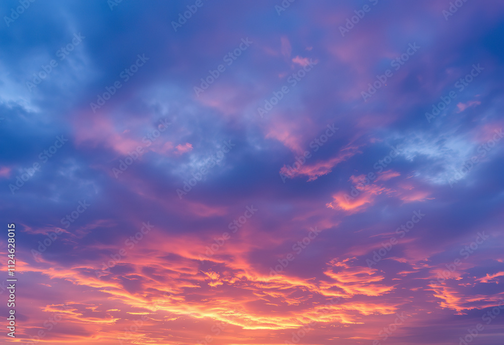 Dramatic cloudy sky with vibrant orange and blue colors at sunset Dramatic cloudy sky with vibrant orange and blue colors at sunset