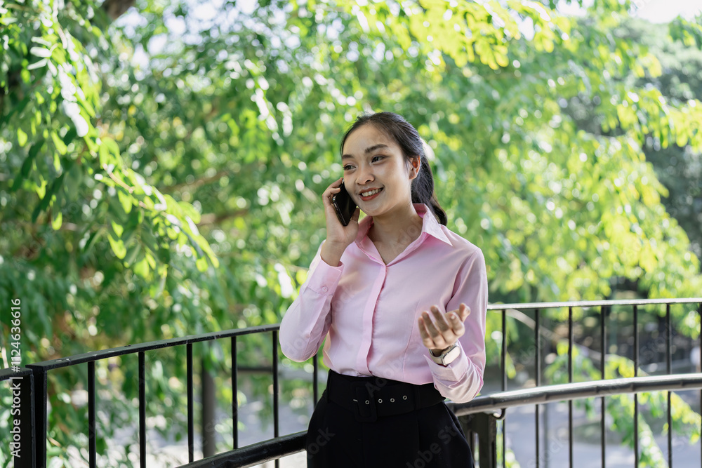 Young professional discusses ideas on phone urban park business portrait greenery side view communication concept Young professional discusses ideas on phone urban park business portrait greenery side view communication concept