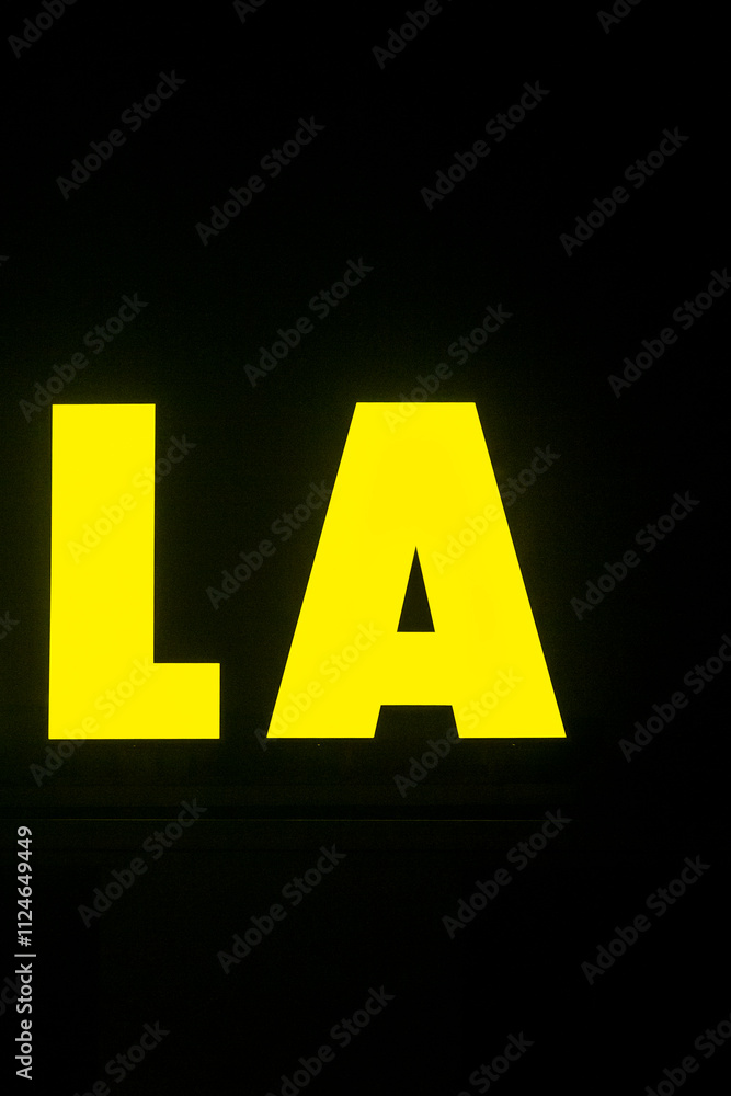 The word la is prominently written in a bright yellow color on a contrasting black background, making it visually striking and attractive The word la is prominently written in a bright yellow color on a contrasting black background, making it visually striking and attractive