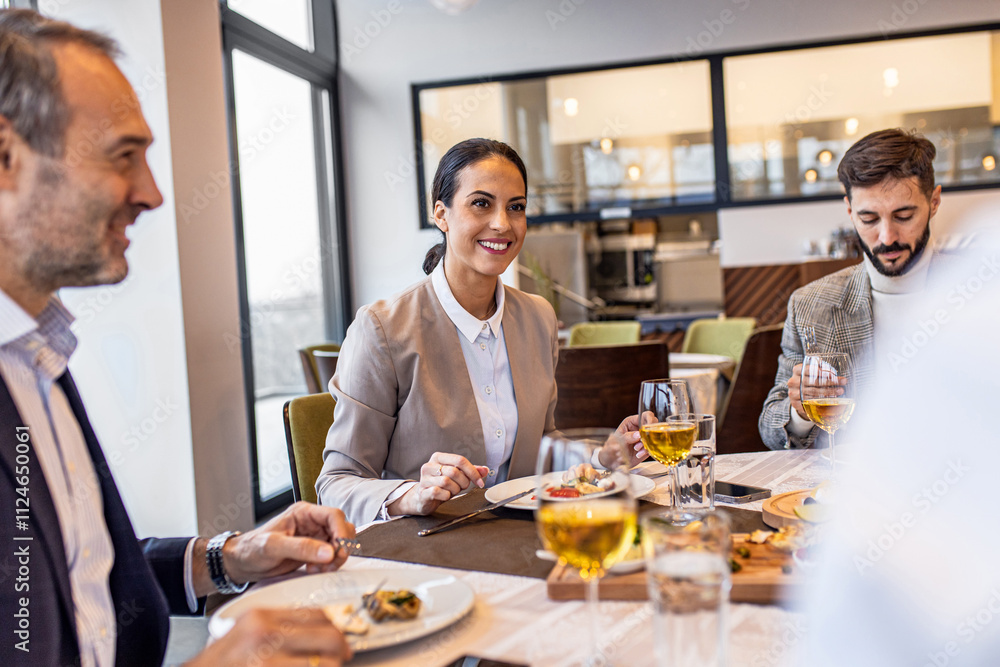 Smiling coworkers in restaurant talking during business lunch. Smiling coworkers in restaurant talking during business lunch.