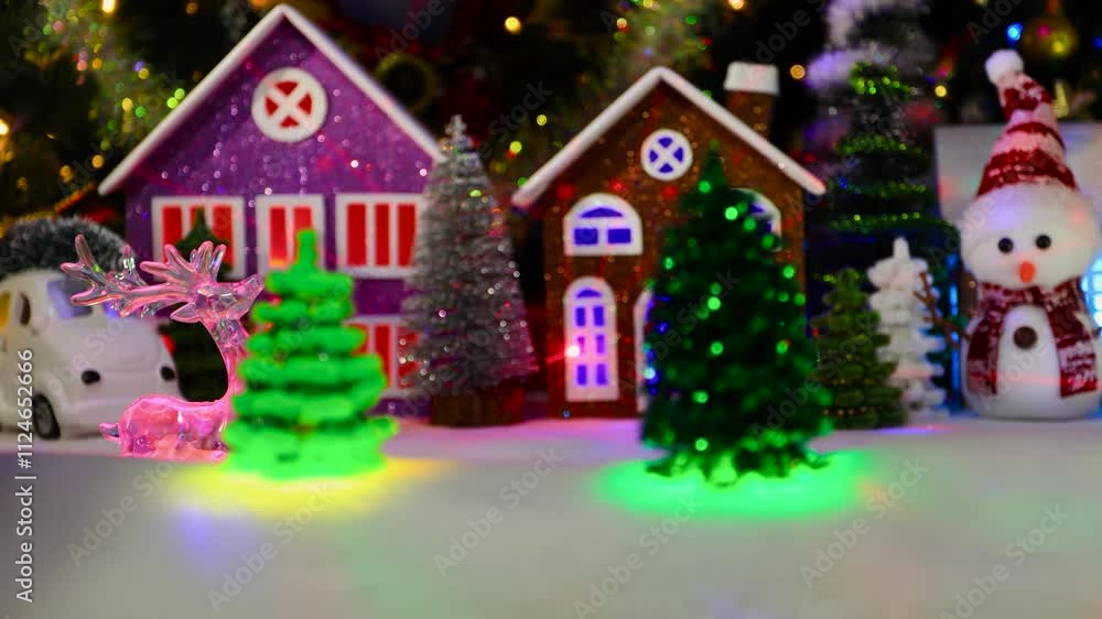 A glass figurine of a deer moves through the middle of a Christmas town A glass figurine of a deer moves through the middle of a Christmas town