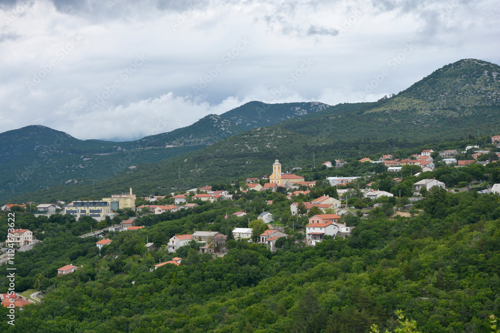 A panoramic view of Hreljin in Croatia reveals a charming village with a church nestled among green hills A panoramic view of Hreljin in Croatia reveals a charming village with a church nestled among green hills