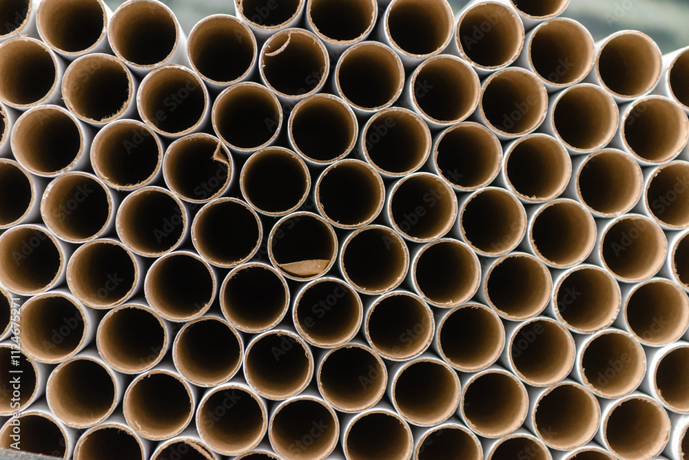 A bunch of brown industrial paper core. A lot of paper cores or paper tubes. Brown paper rolls. A bunch of brown industrial paper core. A lot of paper cores or paper tubes. Brown paper rolls.
