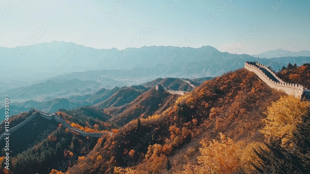 Obraz premium A sweeping view of the Great Wall of China snaking over mountains, covered in autumn foliage.