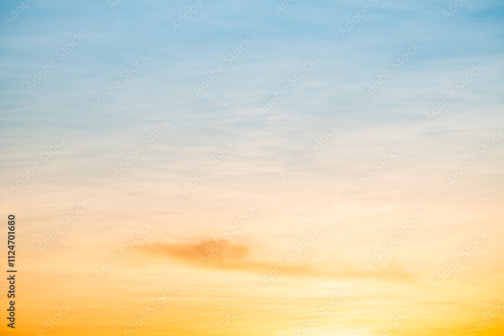 Obraz premium Sky,sunset, beautiful , luxury soft gradient orange gold clouds and sunlight on the blue sky perfect for the background, Sunrise on morning or everning in winter warm time ,Twilight summer,silhouette