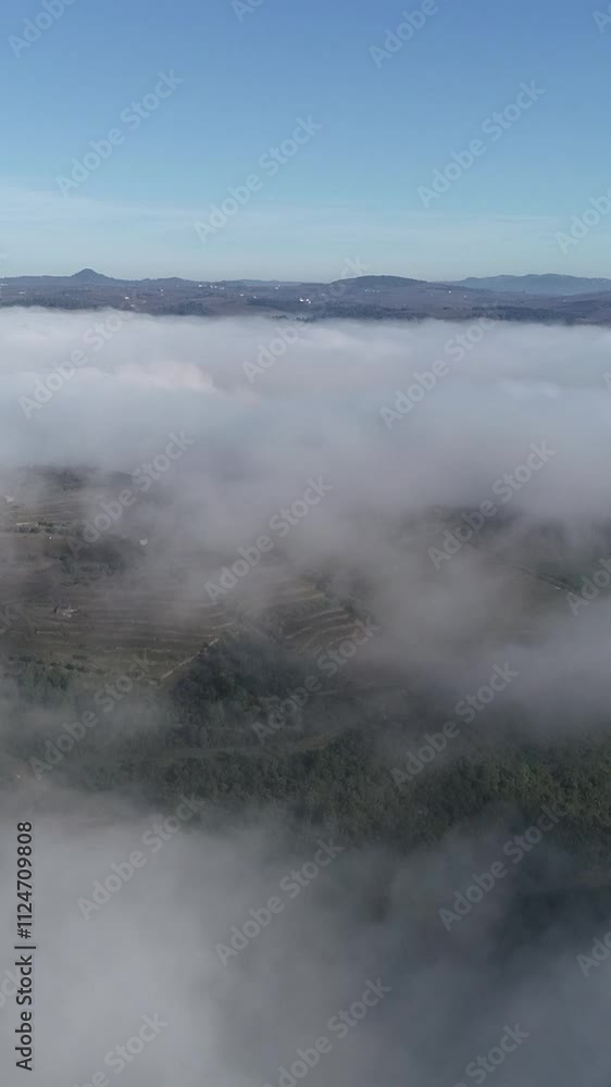Flying towards a mountain over fog Vertical Video Flying towards a mountain over fog Vertical Video