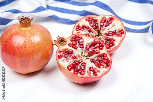 Hanukkah setup with pomegranates and striped fabric photo