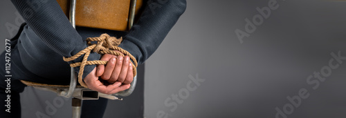 kidnapped man's hands tied with rope, criminal concept