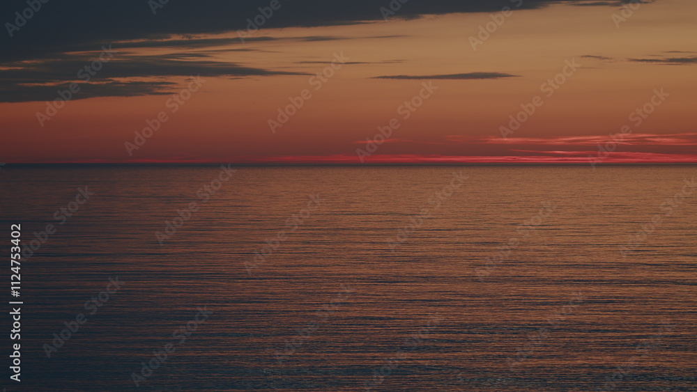 Fototapeta premium Water Ripple Background Texture. Sunlight Reflect On Water Surface. Orange Sea At Sunset.