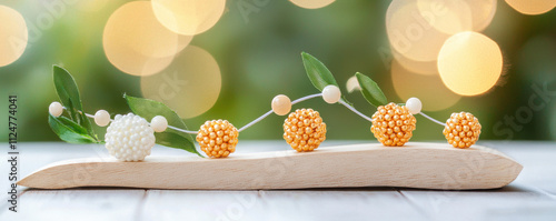 Decorative beads on wooden base with green leaves and soft bokeh background