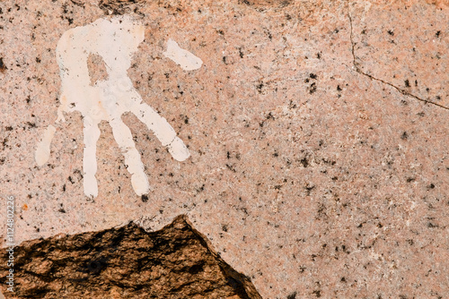 Hand print on cracked and polished stone