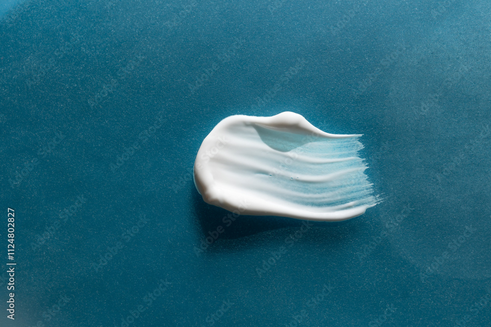 Fototapeta premium A smear of cream on a light background. Beauty concept.