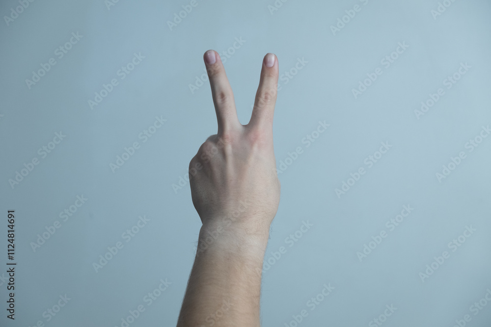 Two fingers isolated on background. Man shows his hand stop sign Two fingers isolated on background. Man shows his hand stop sign