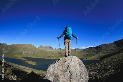 Backpacking woman on high altitude mountain top photo