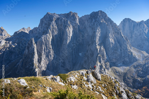 View of the Albanian part of the Prokletije mountains. Couple admiring the mountains, man piloting a drone. Adventure in Montenegro, Volusnica area. photo