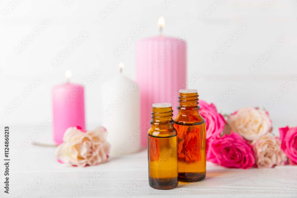 Rose essential oil on a textured background.Roses and a bottle of rose perfumed water.Aromatherapy treatment. Beauty concept. Spa procedure.Natural organic oil.Anti-stress,detox relax.Place for text Rose essential oil on a textured background.Roses and a bottle of rose perfumed water.Aromatherapy treatment. Beauty concept. Spa procedure.Natural organic oil.Anti-stress,detox relax.Place for text
