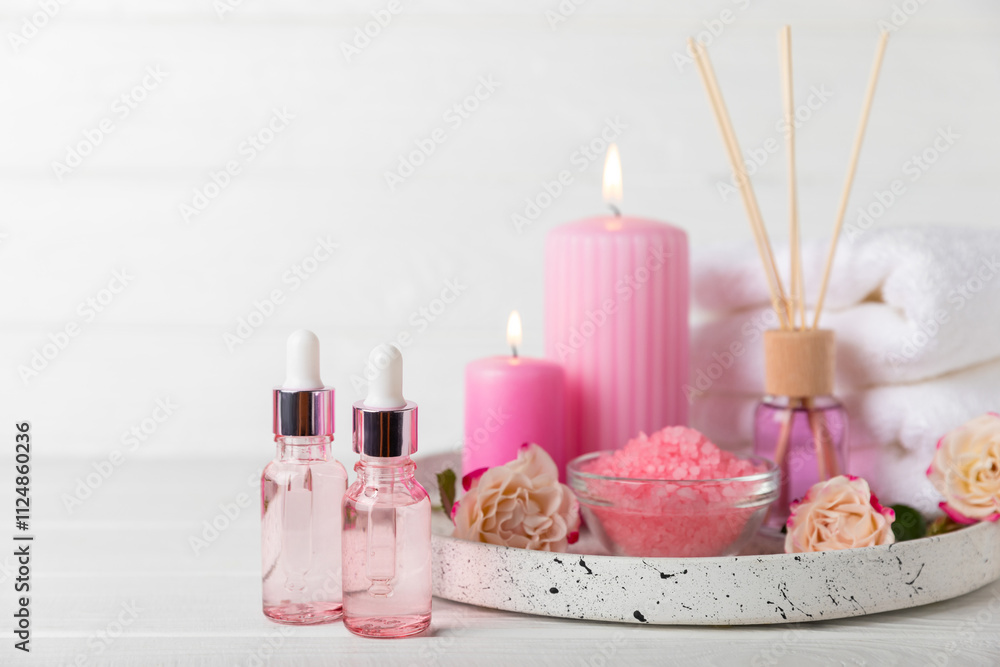 Rose essential oil on a textured background.Roses and a bottle of rose perfumed water.Aromatherapy treatment. Beauty concept. Spa procedure.Natural organic oil.Anti-stress,detox relax.Place for text Rose essential oil on a textured background.Roses and a bottle of rose perfumed water.Aromatherapy treatment. Beauty concept. Spa procedure.Natural organic oil.Anti-stress,detox relax.Place for text