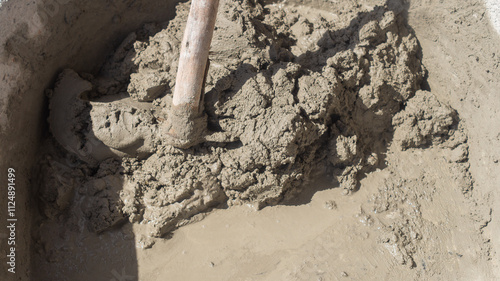 Closeup of cement and clumps in the mixing tray. mixing mortar